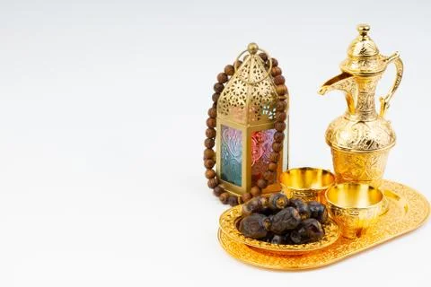 Premium dates, lantern and arabic coffee mug on white background. 库存照片