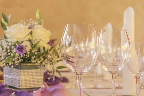 Premium dinner gala table with glasses napkins and flowers. High class arrang Stock Photos