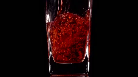 Premium Drink. Super slow motion shot of pouring pomegranate juice into a Stock Footage 147414060