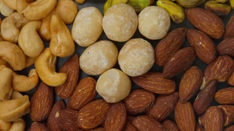 Premium healthy, roasted mixed nuts almonds, cashews, macadamias, and pistachios Stock Footage 320058330