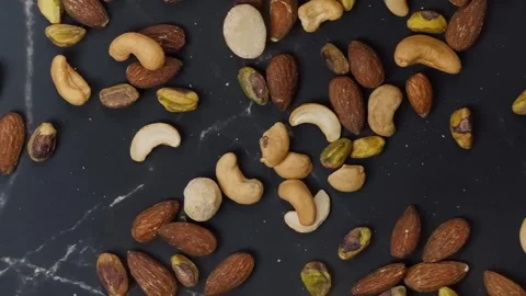 Premium healthy, roasted mixed nuts almonds, cashews, macadamias, and pistachios Stock Footage 320058339