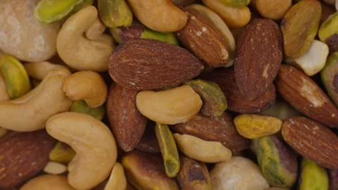 Premium healthy, roasted mixed nuts almonds, cashews, macadamias, and pistachios Stock Footage 320058340