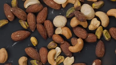 Premium healthy, roasted mixed nuts almonds, cashews, macadamias, and pistachios Stock Footage 320058341