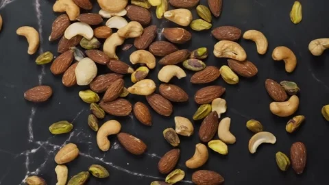 Premium healthy, roasted mixed nuts almonds, cashews, macadamias, and pistachios Stock Footage 320058343