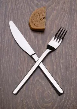 Premium knife and fork. Slice of bread. The end. Stock Photos