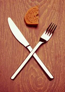 Premium knife and fork. Slice of bread. The end. Retro effect. Stock Photos