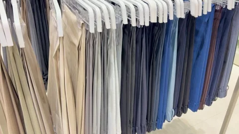 Premium Ready Made formal paints Display On Clothing Rack In Fashion Boutique Stock Footage 340957385