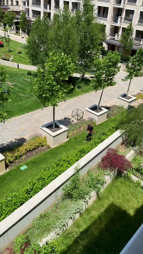 Premium Residential Complex Landscaping Maintenance with Lawn Mowers Stock Footage 337175610