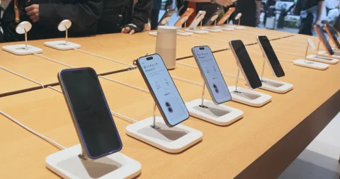 Premium smartphones iPhone 17 Pro screens line at Apple store. Row iPhone demo u Stock Footage 322051578