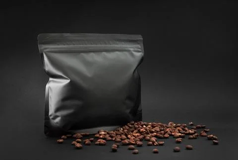Premium specialty coffee foil bag mockup, two dark packages with beans and bl Stock Photos