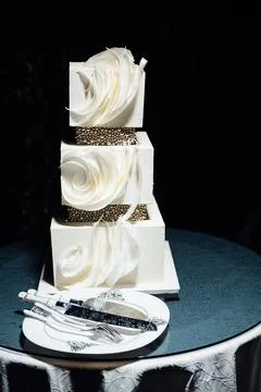 Premium square form wedding cake three floors at the evening ceremony Stock Photos