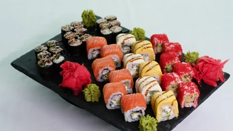 Premium Sushi Platter Rotating on Black Stone Board Video stock 330674560