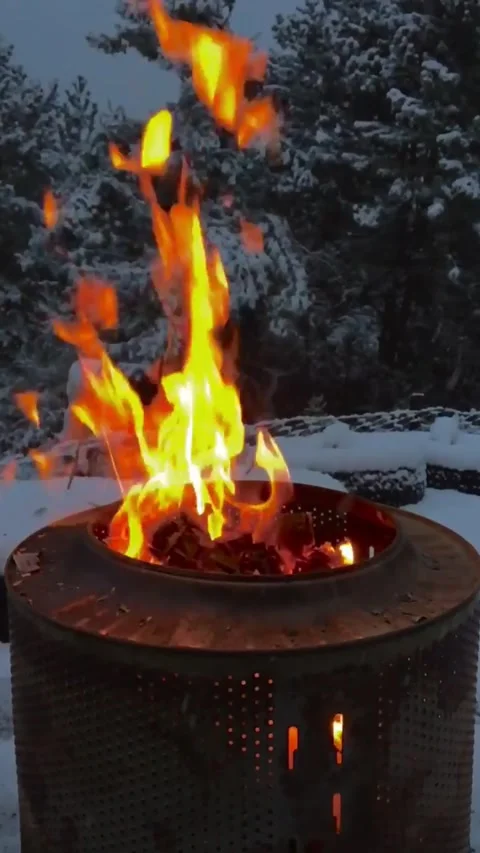 Premium Vertical Cinematic Shot of Fire Burning in a Barrel in Snowy Winter 4K Stock Footage 345168907