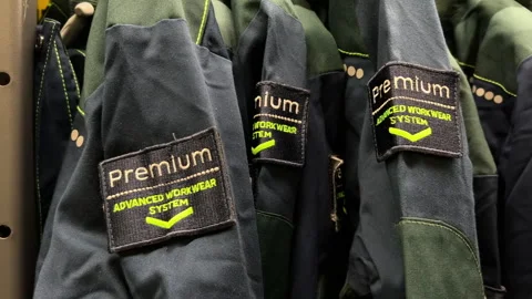 Premium Workwear Jackets Hanging on Store Rack: Industrial Work Cloth Stock Footage 342579195