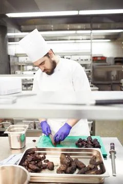 Prep is everything. chefs preparing a meal service in a professional kitchen. Stock Photos