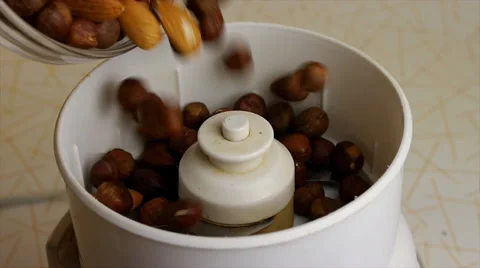 Preparation of almonds and hazelnuts in a blender. Slow motions picture. Stock Footage 33941639