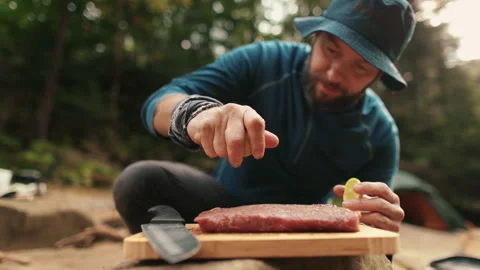 Preparation and marinating of meat in the open air during a tourist trip Stock Footage 256156876