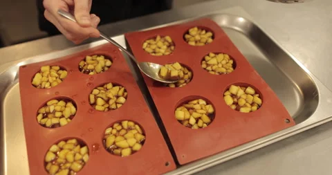 Preparation of apple desserts in a silicone baking tray. Stock Footage 263485824