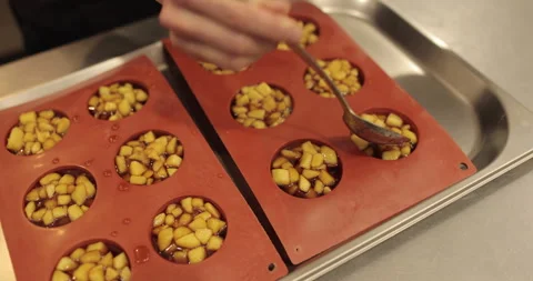 Preparation of apple desserts in a silicone baking tray. Stock Footage 263485892