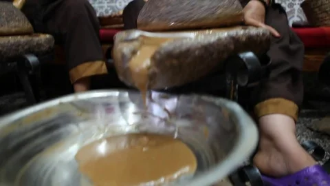 Preparation of argan peanut butter by berber women in Morocco - 1 Stock Footage 80341507