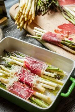 Preparation of asparagus wrapped in Parma ham with cheese Фото