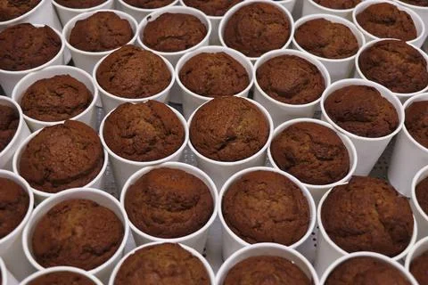 Preparation of baked date pudding in white cups Stock Photos