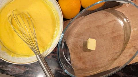 Preparation For Baking Orange Cake With Smooth Batter And Buttered Pan 스톡 사진