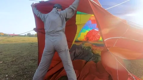 Preparation for a balloon flight. The pilot inflates the balloon with hot air Stock Footage 207517766