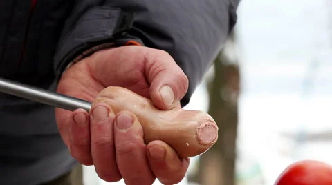 Preparation for the barbecue. Man is stringing a sausages on a metal skewer Stock Footage 63662125