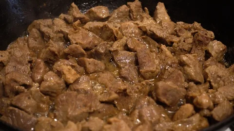 Preparation of beef in cast iron pan. Stock-Footage 124935196