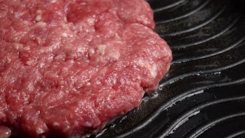 Preparation of beef cutlets. cutlet is fried in a grill pan, close-up Stock Footage 197023222