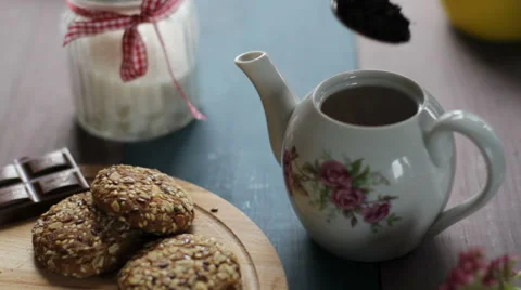Preparation of black tea in the kettle. Pour hot tea in a white ceramic Cup with Stock Footage 68906106
