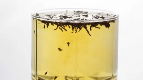 Preparation of black tea in a transparent glass cup Stock Footage 239226502