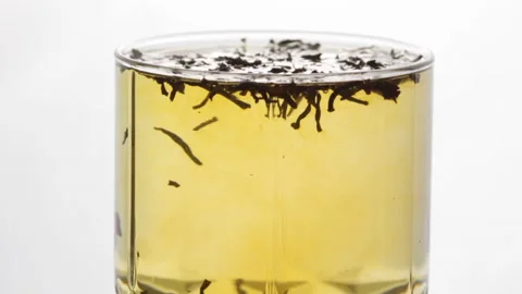 Preparation of black tea in a transparent glass cup Stock Footage 239226509