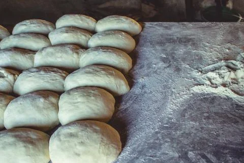 Preparation of bread rolls from dough on a table with flour Stock Photos