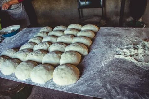 Preparation of bread rolls from dough on a table with flour Stock Photos