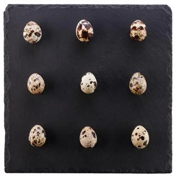 Preparation for the celebration of Easter. A set of quail eggs on a black bac Stock-Fotos