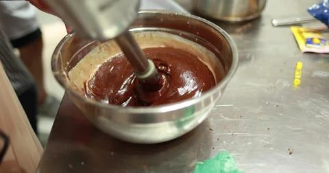 Preparation of chocolate mousse using an immersion blender in a professiona.. Stock Photos