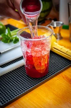 Preparation of cocktail. Adding ice, shaking ingredients and decorating with  Stock Photos