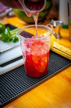 Preparation of cocktail. Adding ice, shaking ingredients and decorating with  Stock Photos