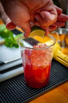 Preparation of cocktail. Adding ice, shaking ingredients and decorating with  Stock Photos