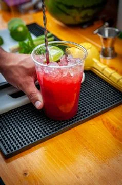 Preparation of cocktail. Adding ice, shaking ingredients and decorating with  Stock Photos