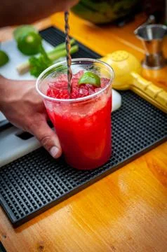 Preparation of cocktail. Adding ice, shaking ingredients and decorating with  Stock Photos