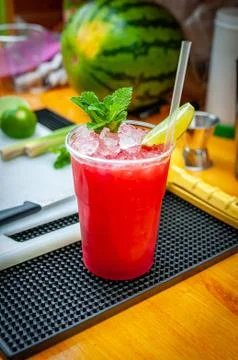 Preparation of cocktail. Adding ice, shaking ingredients and decorating with  Stock Photos