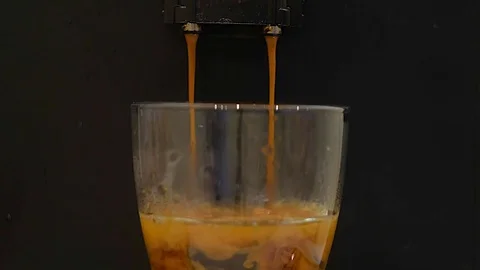 Preparation of coffee in the coffee machine espresso, close up.Fresh coffee from Stock Footage 83307322