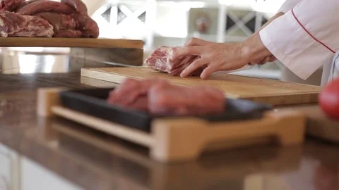 Preparation for cooking. The chef carving the beef Stock Footage 78129193