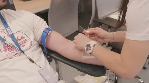 Preparation for donating blood and inserting a needle into the arm Stock Footage 237002663