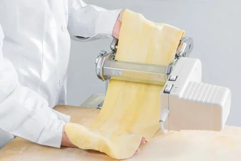 Preparation of the dough, with an electric machine, to make fresh homemade pasta Stock Photos