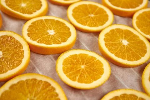Preparation of dried oranges. Selective focus on fresh orange slices. Close u Stock Photos