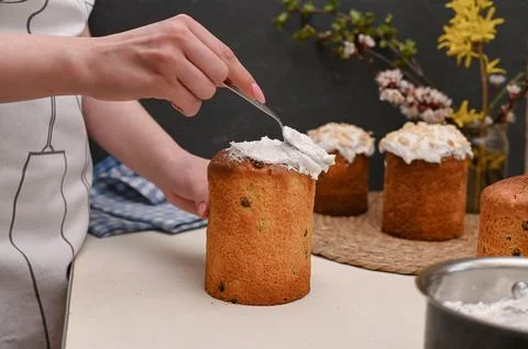 Preparation of Easter cakes. applying the cream. Stock Photos